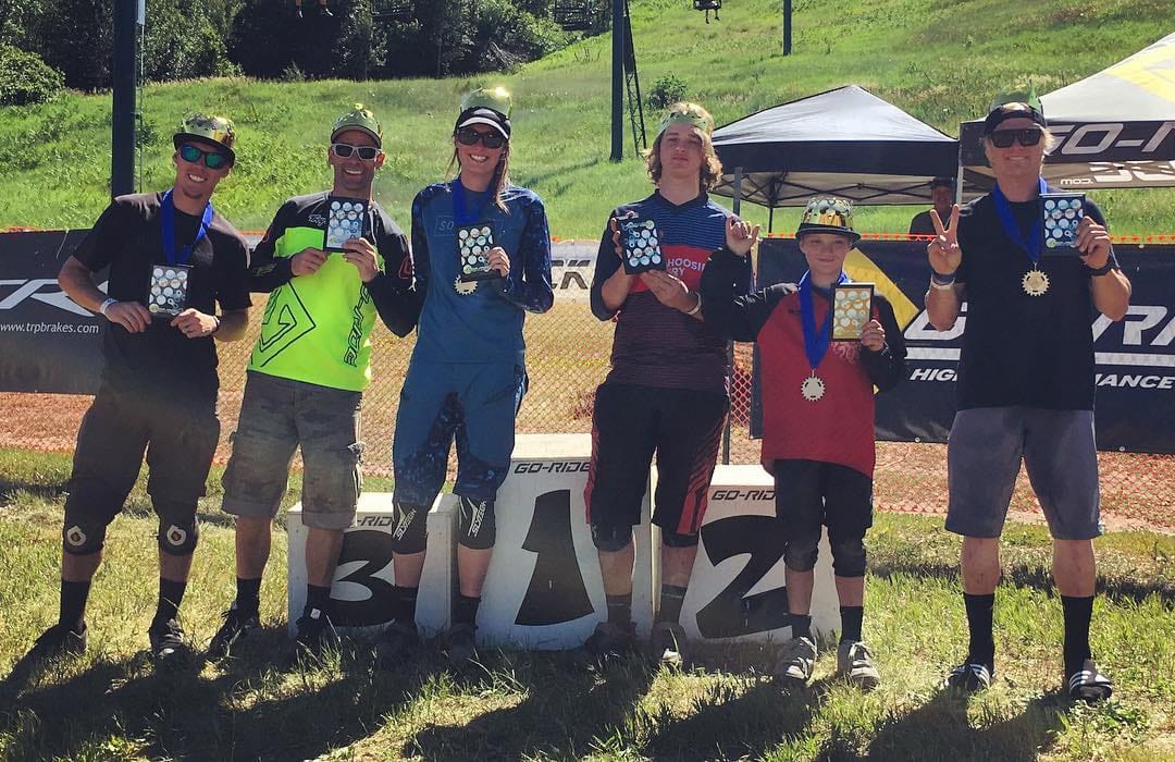 Pro riders celebrating on the podium at awards